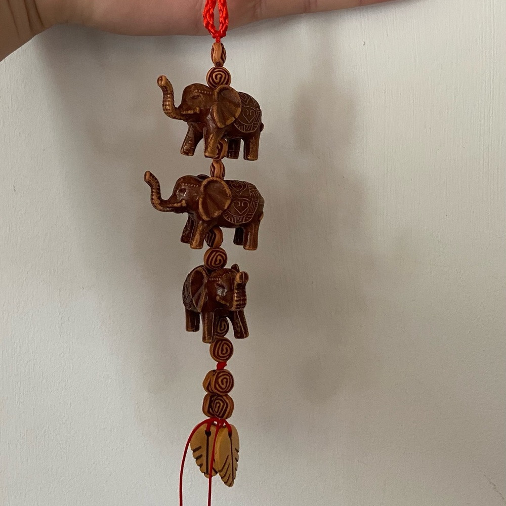 Red mirror keychain with wood elephants